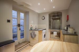 a kitchen with a sink and a washing machine at Tide & Teacups in Brighton & Hove