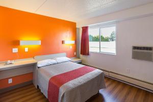 a room with a bed and a desk and a window at Motel 6-Spokane, WA - East in Spokane Valley