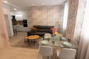 a living room with a table and a couch at Camino Termal OURENSE in Valenzana
