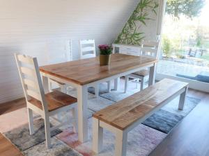 a wooden table and chairs in a room at Ferienhaus am Tannenbad in Bergen an der Dumme