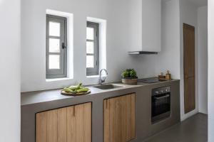 a kitchen with a plate of bananas on a counter at Acron Villas Paros in Kolympithres