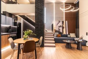 a living room with a table and a couch at MoonLight Lofts APHRODITE & POSEIDON in Alexandroupoli