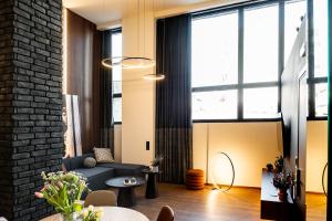 a living room with a couch and a table at MoonLight Lofts APHRODITE & POSEIDON in Alexandroupoli +71 photos