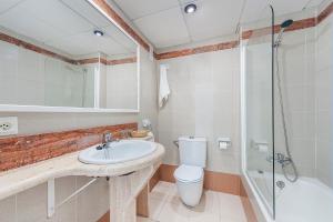 a bathroom with a sink and a toilet and a shower at Hostal Brisa Marina in Port d'Alcudia
