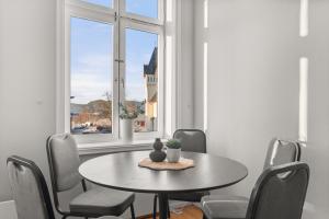 a dining room with a table and chairs and a window at Halden Grand hotell in Halden