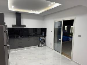 a kitchen with a washer and dryer in a room at Dar khadouja in Taguermess