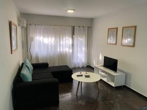 a living room with a couch and a table at Microcentro Mendoza in Mendoza