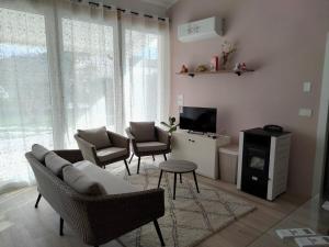 a living room with a couch and chairs and a tv at Tra Toscana e Umbria in Monterchi