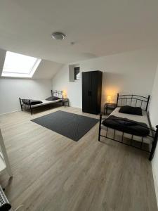 a bedroom with two beds and a skylight at Gemeinschaftswohnung mit privaten Zimmern in Diepholz