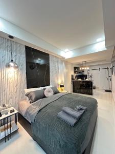 a bedroom with a large bed with towels on it at Viraplace1# in Pattaya Central