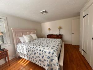 a bedroom with a bed and two night stands at 3 Shore Road Extension West Harwich Cape Cod - - A Shore Thing in West Harwich +10 photos