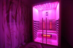 a purple lighted room with a wine rack in it at SPA Villa ALEMI, Private Pool, Sauna & Free Parking in Brodarica
