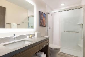 a bathroom with a sink and a shower at Candlewood Suites Huntsville - Research Park by IHG in Huntsville +15 photos
