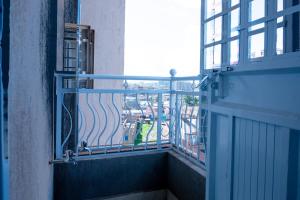 a balcony with a view of a city from a building at Quiet a Gem off Thika Highway in Ruiru