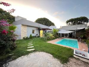 a house with a swimming pool in the yard at Casa temporada in Camaçari +15 photos