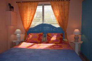 a bedroom with a bed with two lamps and a window at Sun Caraibes in Orient Bay
