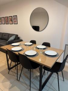a dining room table with chairs and a mirror at Cala Paula in Lloret de Mar