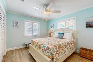 a bedroom with a bed and a ceiling fan at A Sandy Shore in Panama City Beach