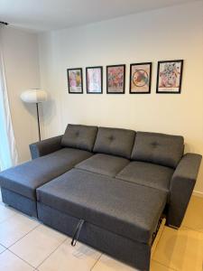 a couch in a living room with pictures on the wall at Cala Paula in Lloret de Mar +45 photos
