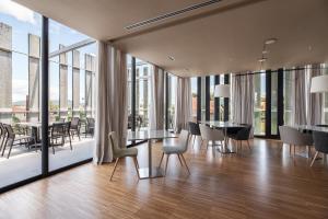 a dining room with floor to ceiling windows at Pousada Ribadumia in Ribadumia