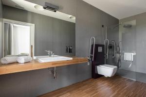 a bathroom with a sink and a shower and a toilet at Pousada Ribadumia in Ribadumia +28 photos