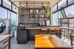 a bar in a restaurant with a wooden table at Spot Jurere sophistication by the sea - SPJ's in Florianópolis