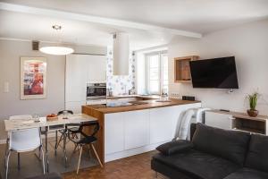 a kitchen and living room with a couch and a table at Muzyczna Oaza Przy Rynku in Wrocław