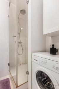 a bathroom with a washing machine and a shower at Muzyczna Oaza Przy Rynku in Wrocław +57 photos
