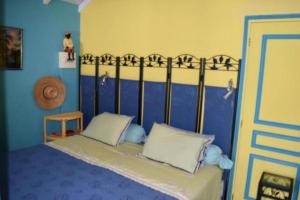 a bedroom with a bed with a blue wall at Sun Caraibes in Orient Bay