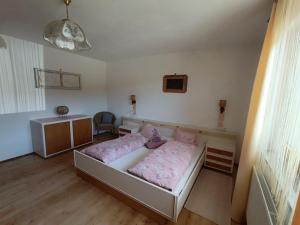 a bedroom with a bed with a teddy bear on it at Ferienwohnung Marchnerhof in Terento +3 photos