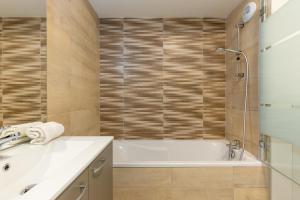 a bathroom with a tub and a sink at Le 72 contemporain - les Arènes in Metz +32 photos