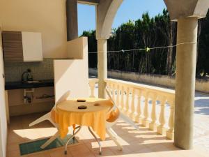 a table on the balcony of a house at Agriturismo Antico Vigneto in Otranto