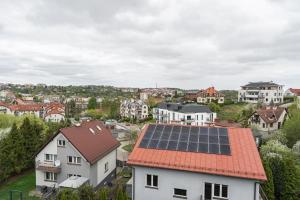 a house with solar panels on its roof at Apartament Pomarańczowy Gdańsk 80 metrów z widokiem na ogród in Gdańsk