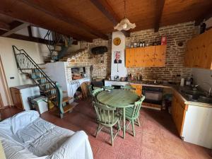 a kitchen with a table and chairs in a room at Borgo Antico Satriano in Satriano