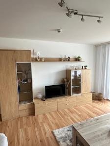 a living room with a large wooden entertainment center at Schwarzwald Studio in Freudenstadt
