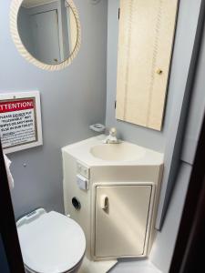 a bathroom with a sink and a mirror and a toilet at Keys Livin - Yacht Rental in Key West +42 photos