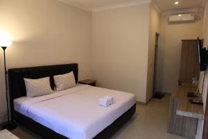 Postel nebo postele na pokoji v ubytování Rahayu Hotel Cirebon