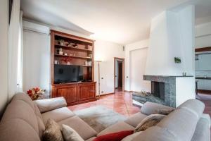 a living room with a couch and a fireplace at Carso - Family Apartment with parking in Como