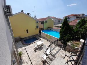 a view of a swimming pool from a balcony at Luxury 3BR Duplex with Pool 2 Mins from Beach in Kumbor in Herceg-Novi +8 photos