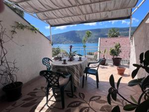 a table on a patio with a view of the water at The Golden Hour in Herceg-Novi