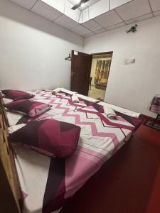 a large bed with pillows on it in a room at kingjey famiy in Kalpitiya
