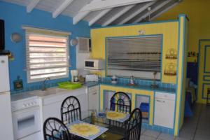 a kitchen with a play kitchen with a table and chairs at Sun Caraibes in Orient Bay