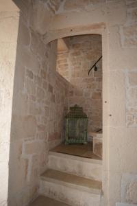 a stone room with stairs in a stone wall at Martine Dimore Storiche di Puglia in Martina Franca