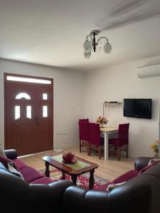 a living room with a couch and a table at Guest House Miracle Garden in Vlorë
