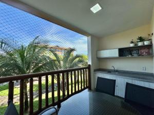 a balcony with a view of a palm tree at VG SUN CUMBUCO 2 quartos - B2, apto 205 in Cumbuco