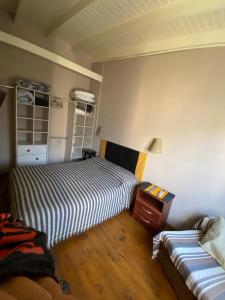 a bedroom with two beds and a table and a couch at Departamento en Campana 3 in Campana +7 photos