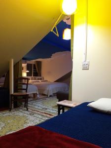 a room with two beds and a yellow ceiling at Thai River House in Ban Kat Khi Lek