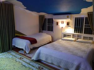 a bedroom with two beds and a blue ceiling at Thai River House in Ban Kat Khi Lek +28 photos