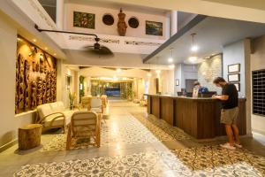 a man standing at a bar in a hotel lobby at Park Hotel in Santa Marta +59 photos