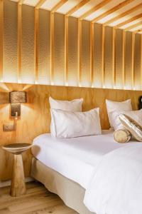 two beds with white pillows in a room at Hôtel Les Aiglons Chamonix in Chamonix-Mont-Blanc